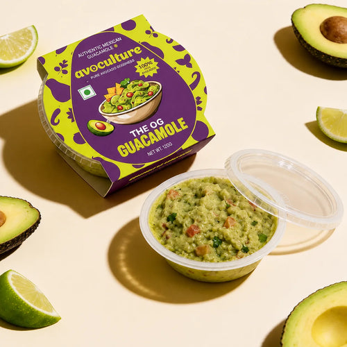 The OG Guacamole carton beside an open tub, with avocado halves and lime wedges